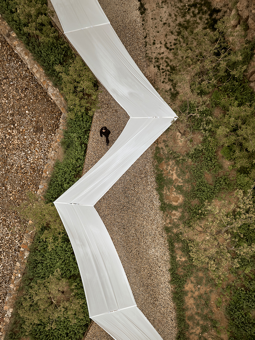 team_bldg's white gauze installation flutters and chimes soft bells in ancient valley in china