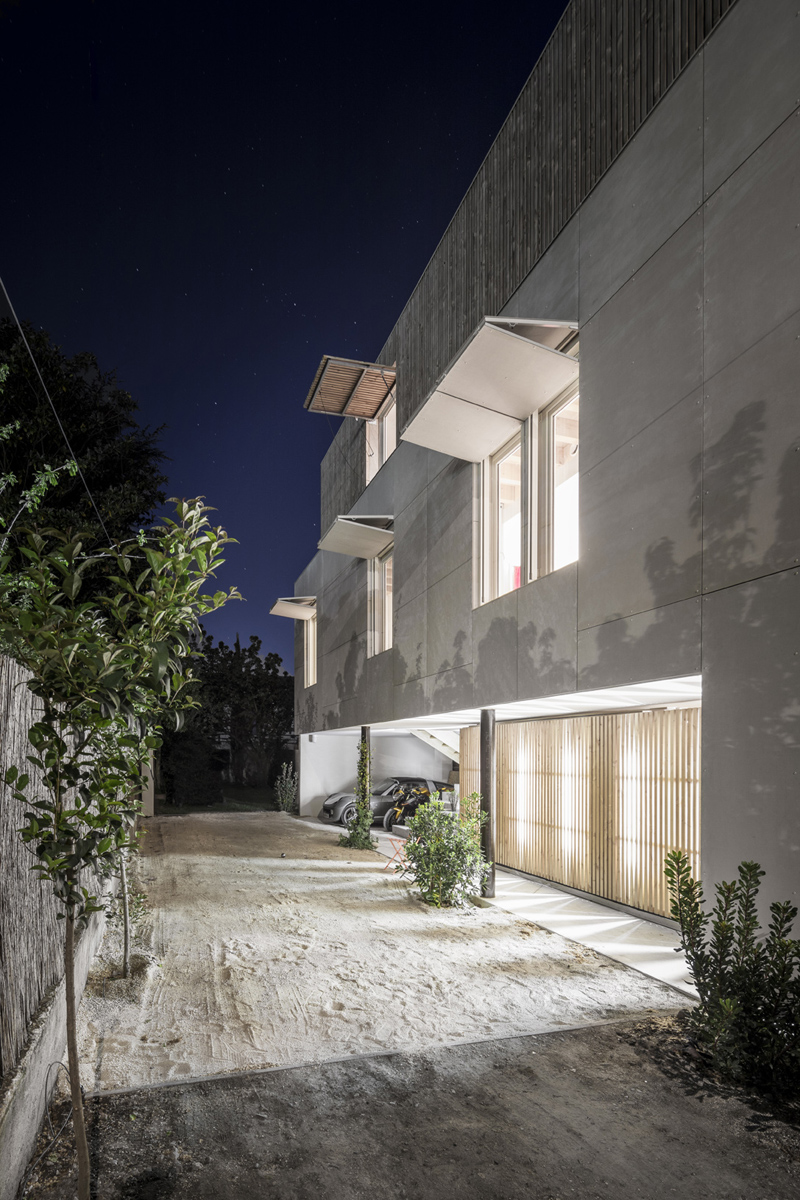 this concrete building by raphael azalbert is decorated with wooden grills