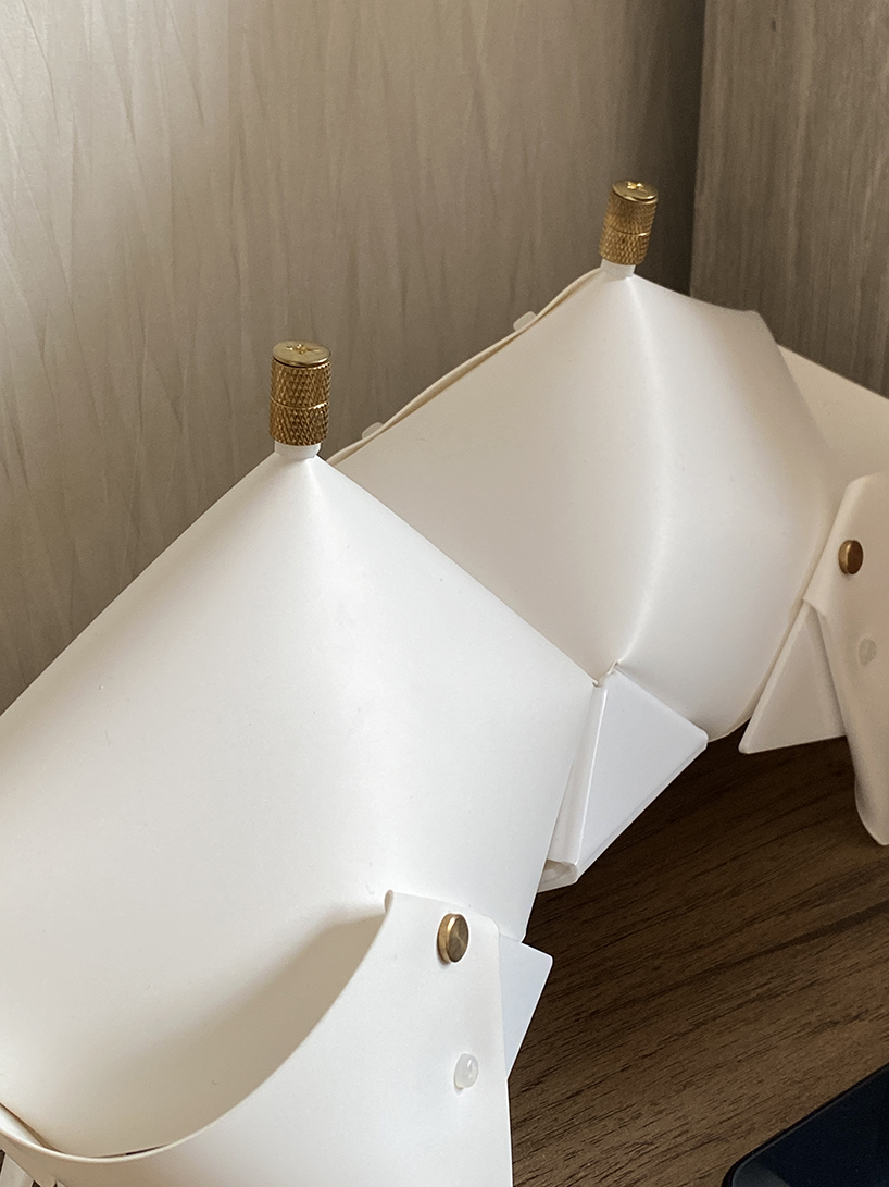 La lámpara de cangrejo de origami se pliega y se convierte en una mesita de noche que emite un brillo suave.