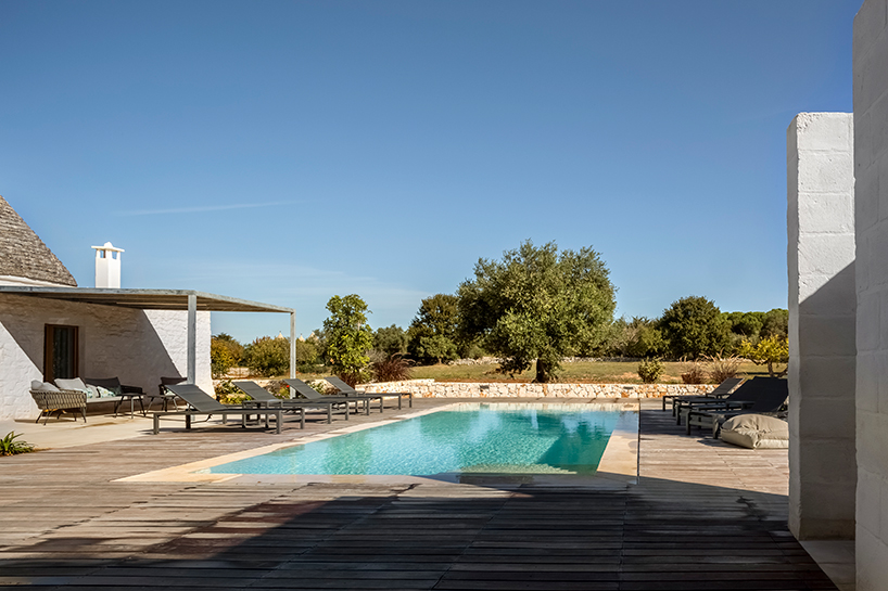 reisarchitettura's L-shaped extension completes traditional stone house with six trulli in italy