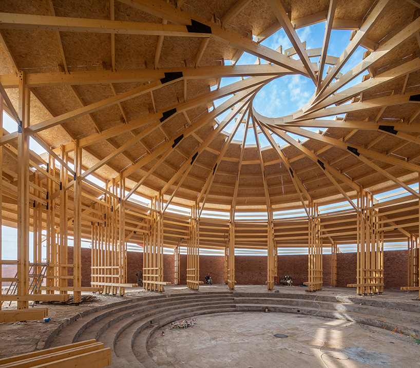 LUO studio tops exhibition hall in china with spiral wooden roof frame