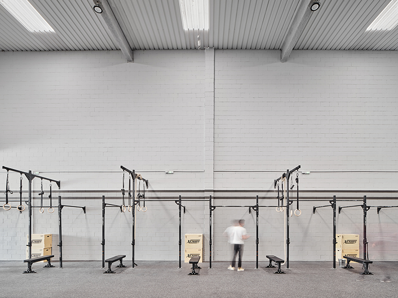 auba studio's sleek steel intervention turns former warehouse into fitness center in spain