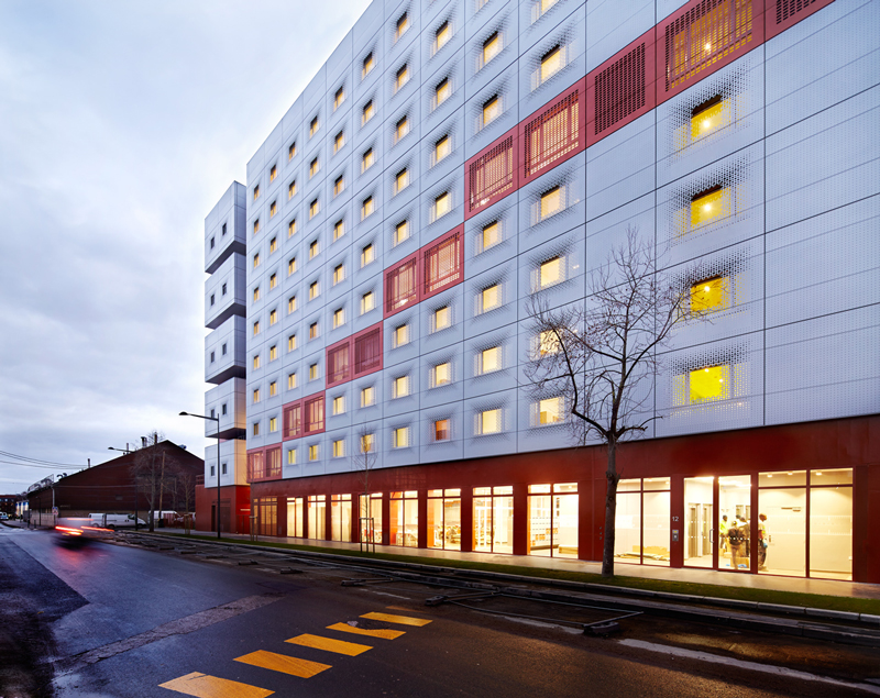 white & bright red perforated metal facade clads student housing by BFV in france