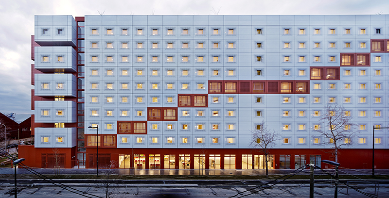 white & bright red perforated metal facade clads student housing by BFV in france