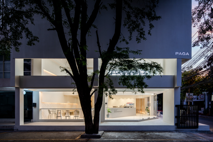 warm neutrals and soft curves shape PAGA microroastery in bangkok