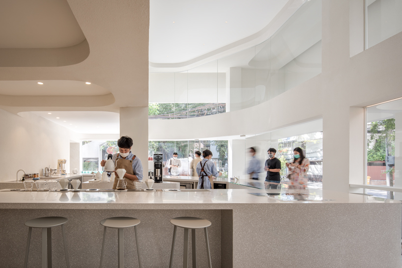 warm neutrals and soft curves shape PAGA microroastery in bangkok designboom