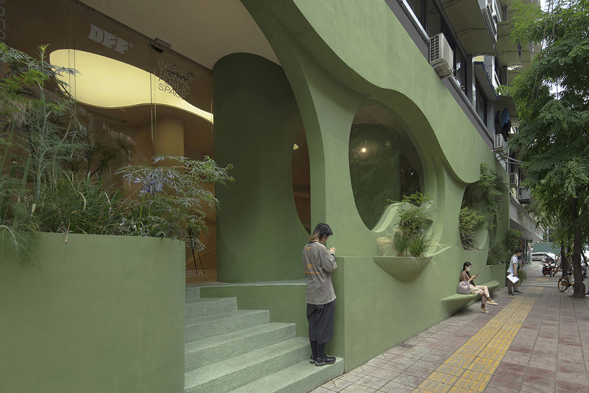 irregular curves bring the nature inside this pastel green café in china 