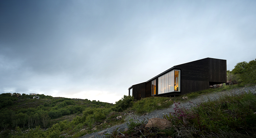 kappland arkitekter places cabin on steep, seaside slope in norwegian ...