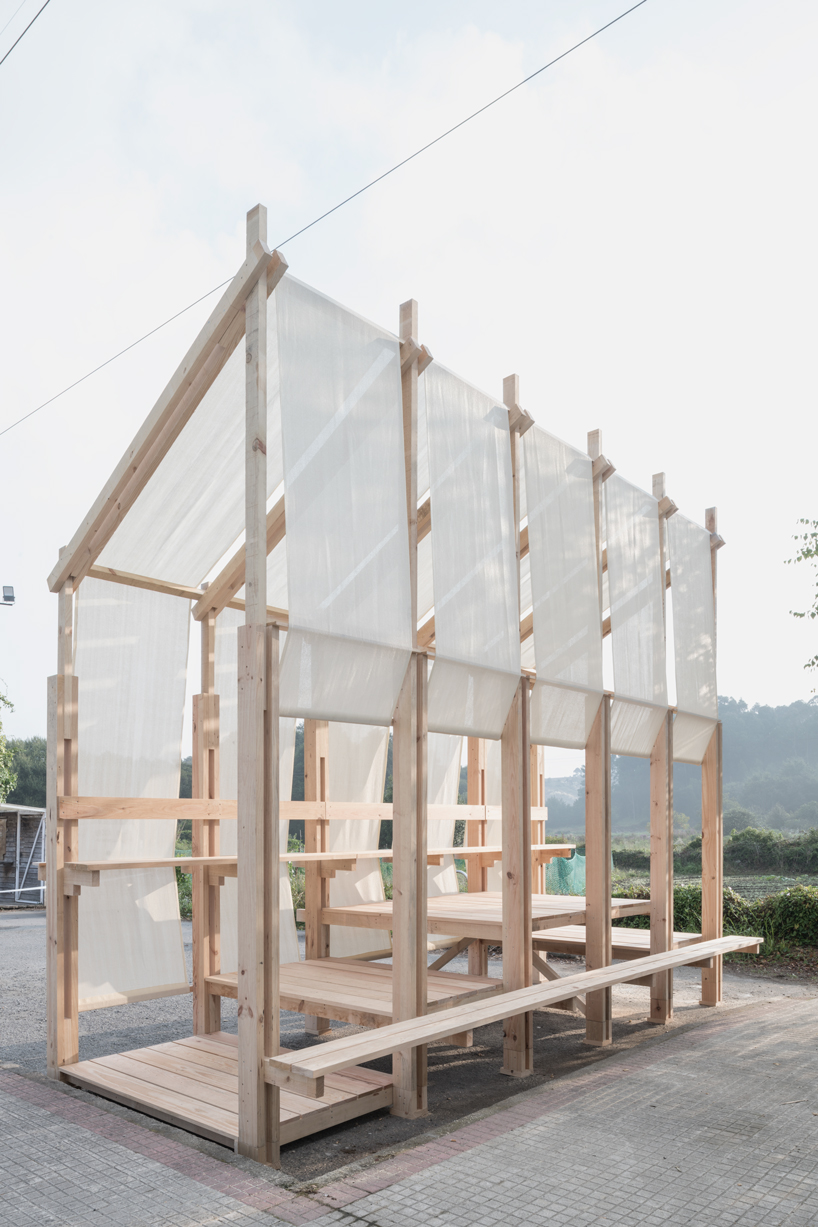 erazo pugliese and cesuga cover modular wooden installation's frame with translucent fabrics