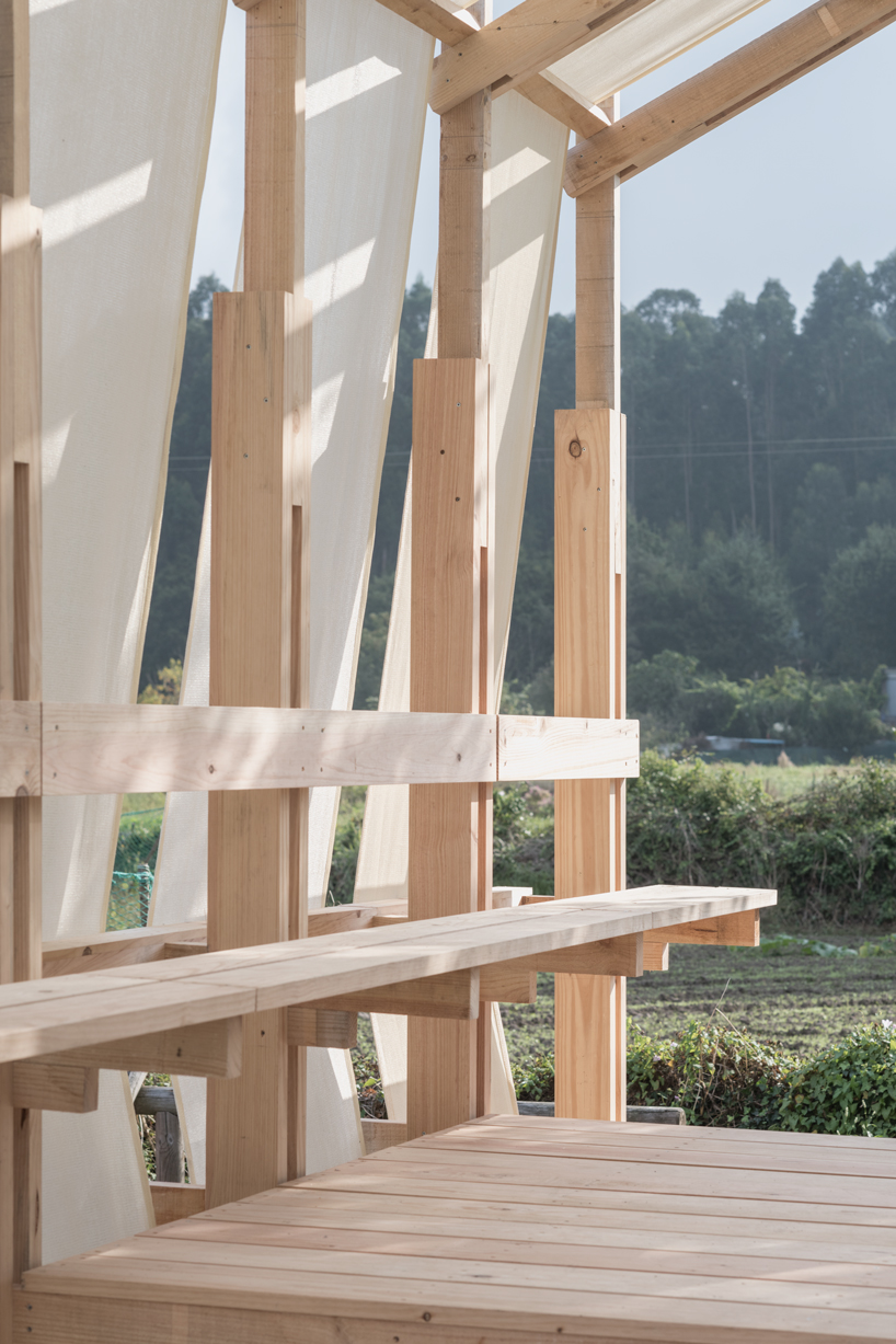 erazo pugliese and cesuga cover modular wooden installation's frame with translucent fabrics