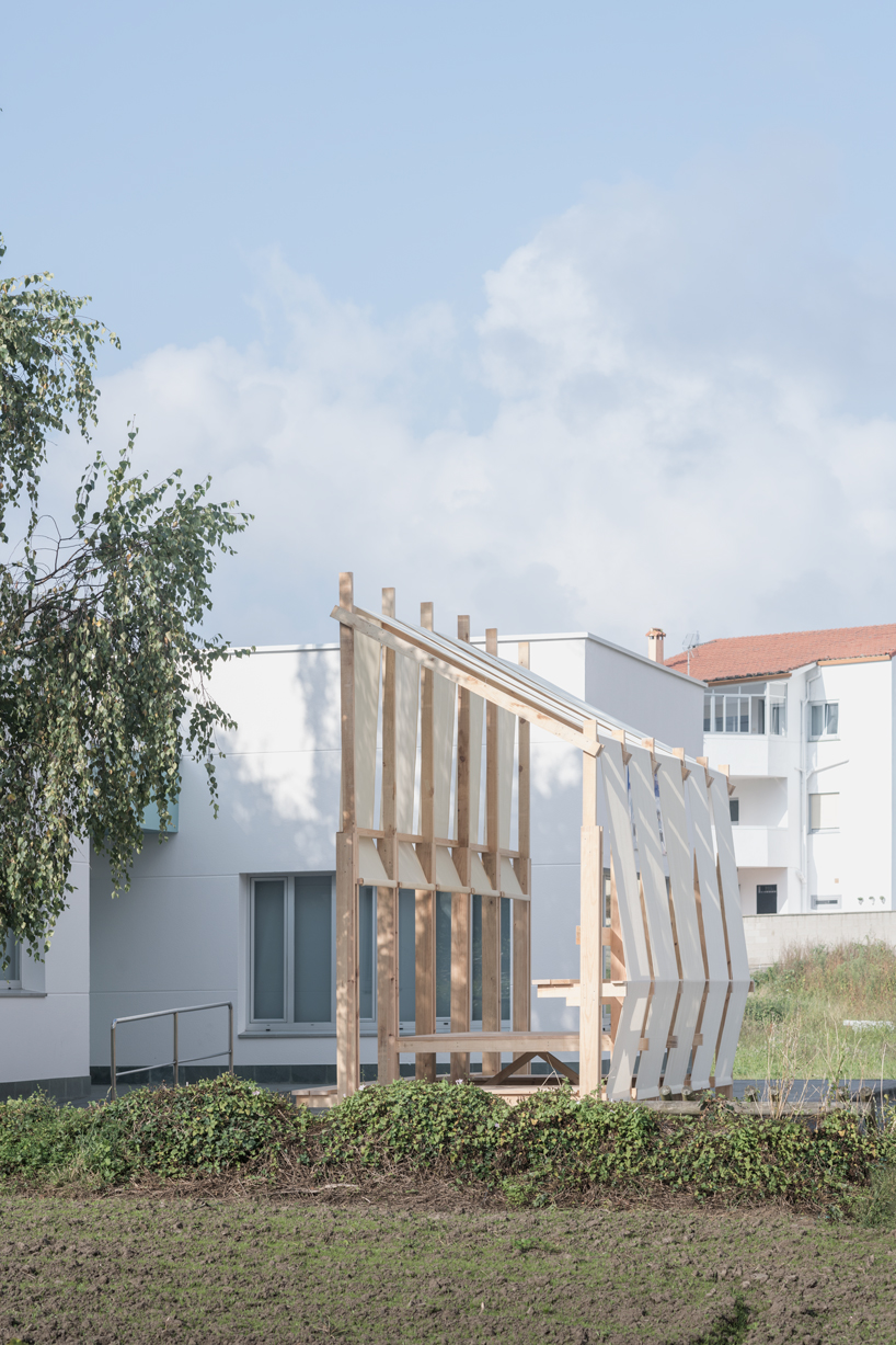 erazo pugliese and cesuga cover modular wooden installation's frame with translucent fabrics