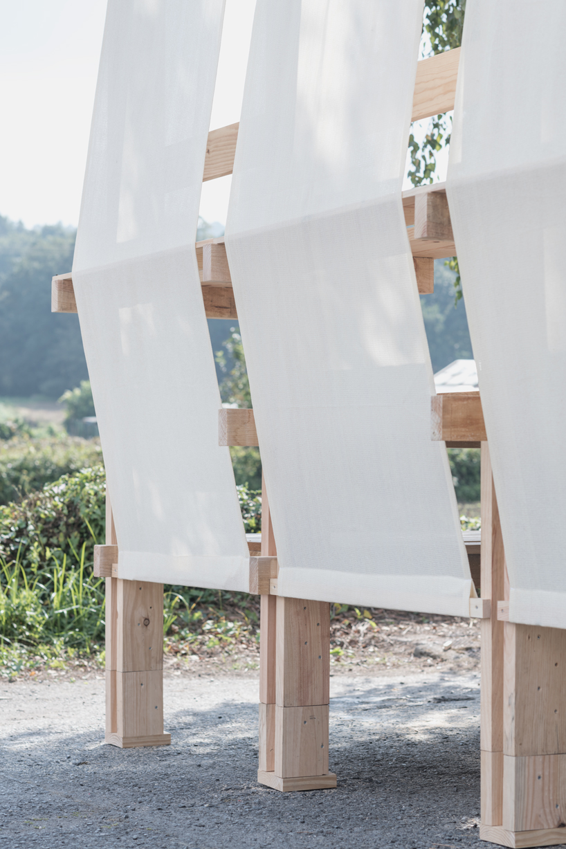 erazo pugliese and cesuga cover modular wooden installation's frame with translucent fabrics