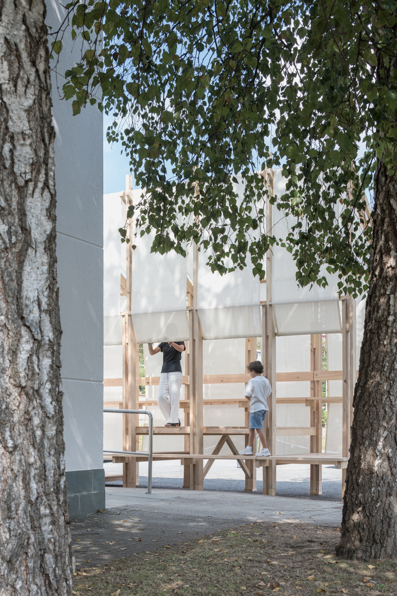 erazo pugliese and cesuga cover modular wooden installation's frame with translucent fabrics