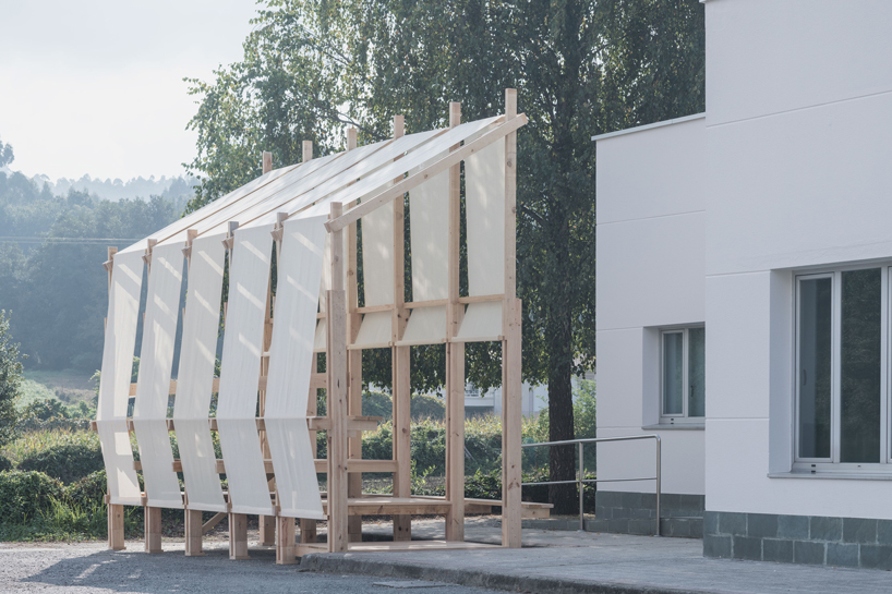 erazo pugliese and cesuga cover modular wooden installation's frame with translucent fabrics