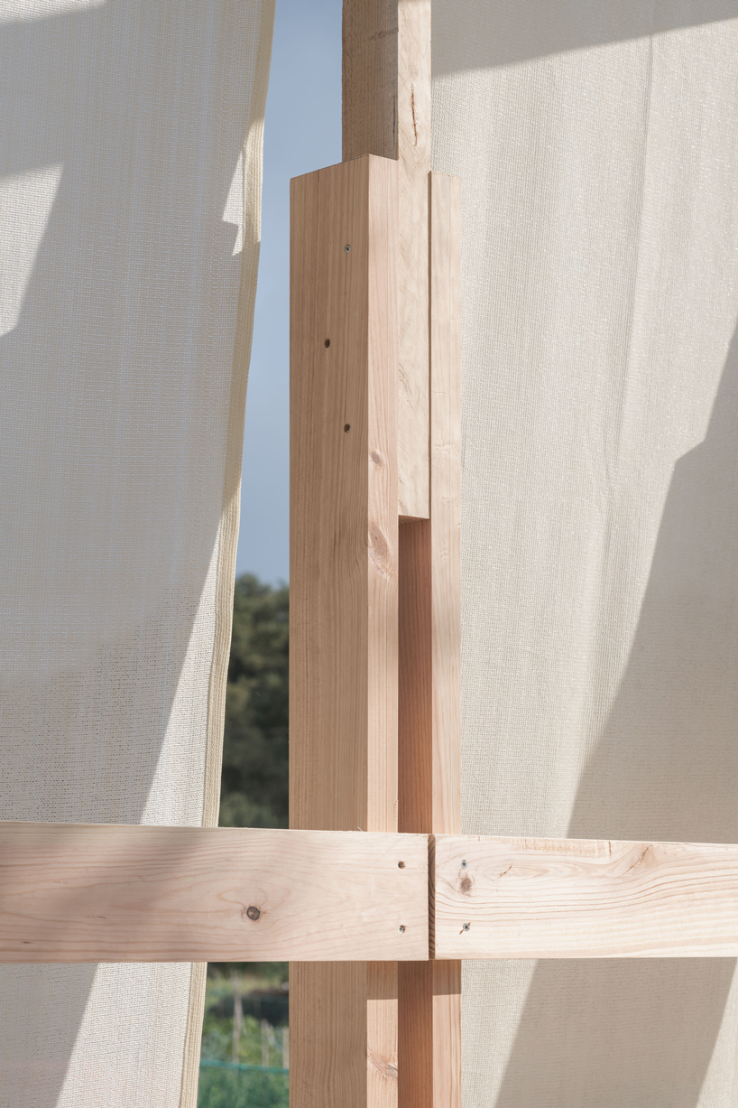 erazo pugliese and cesuga cover modular wooden installation's frame with translucent fabrics