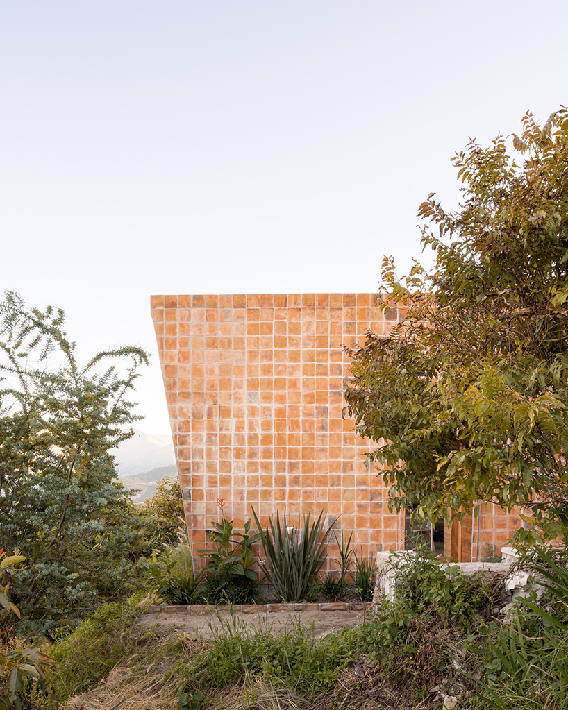 uniform skin of bricks coats casa perucho's facades in ecuador