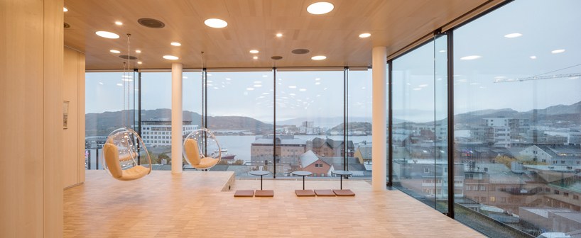 studio ALL's faceted stone facade plays with light on city hall in norway