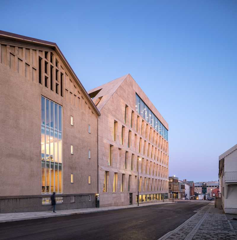 studio ALL's faceted stone facade plays with light on city hall in norway