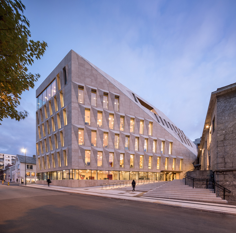 studio ALL's faceted stone facade plays with light on city hall in norway