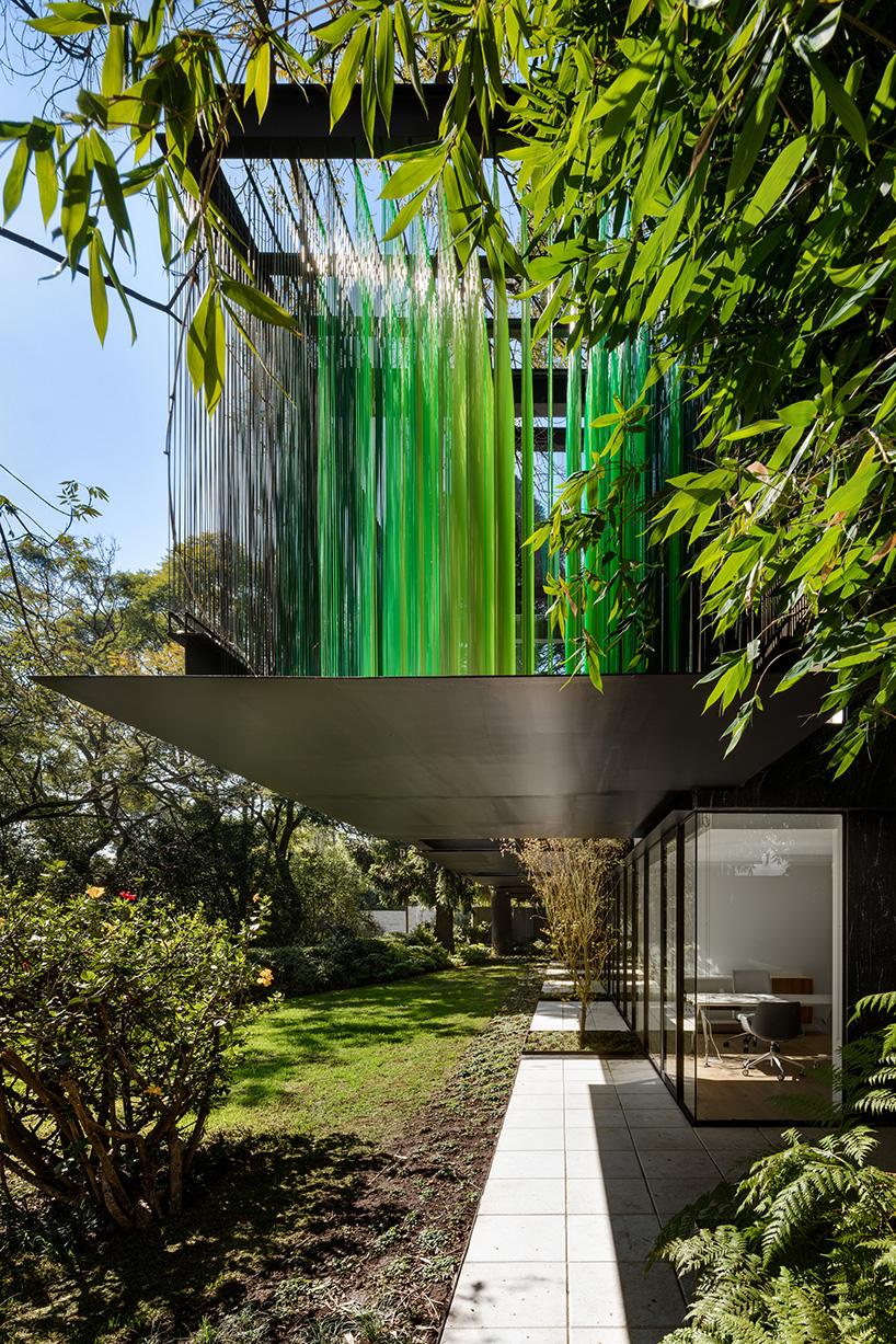 archetonic applies a layer of permeable green cables to office façade in mexico city designboom