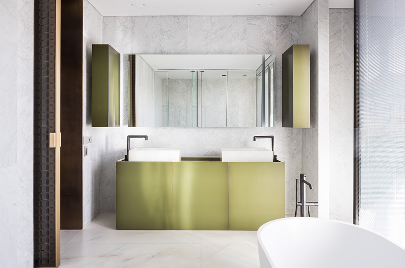 yoma architects clads luxury penthouse in marble and brass detailing in jerusalem