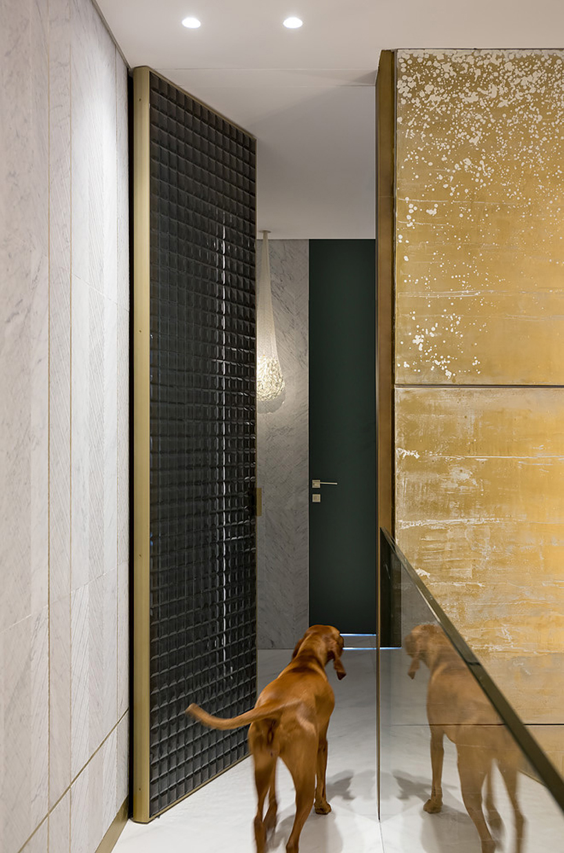 yoma architects clads luxury penthouse in marble and brass detailing in jerusalem