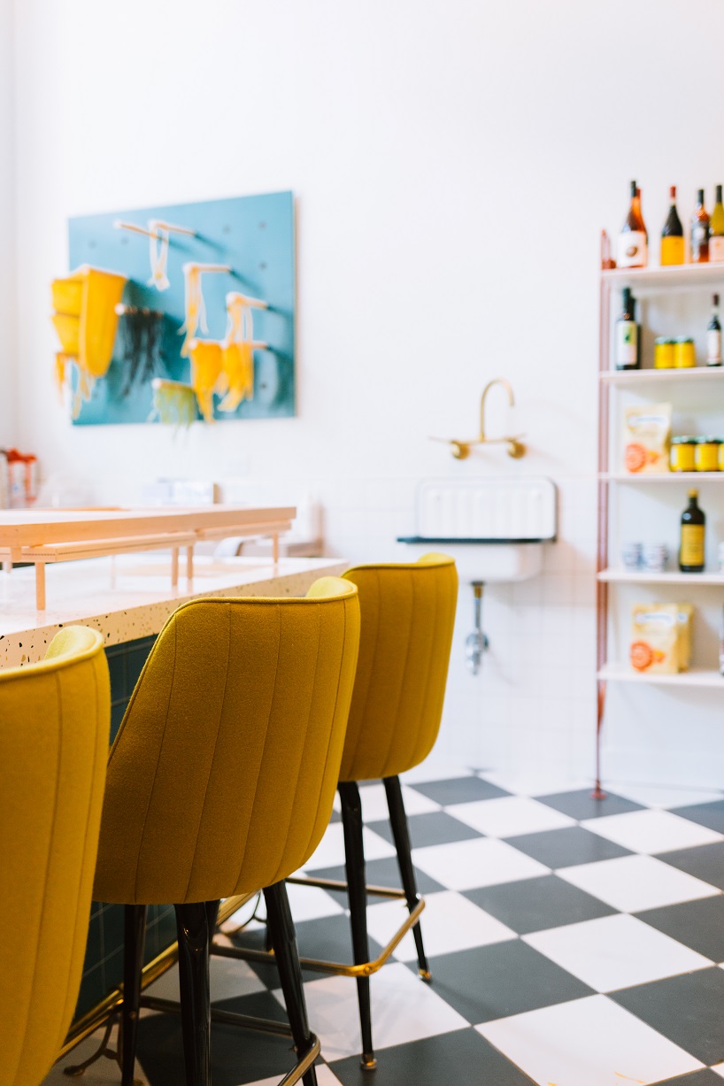 siren betty design suspends a teal blue vespa in chicago's tortello pasta shop designboom