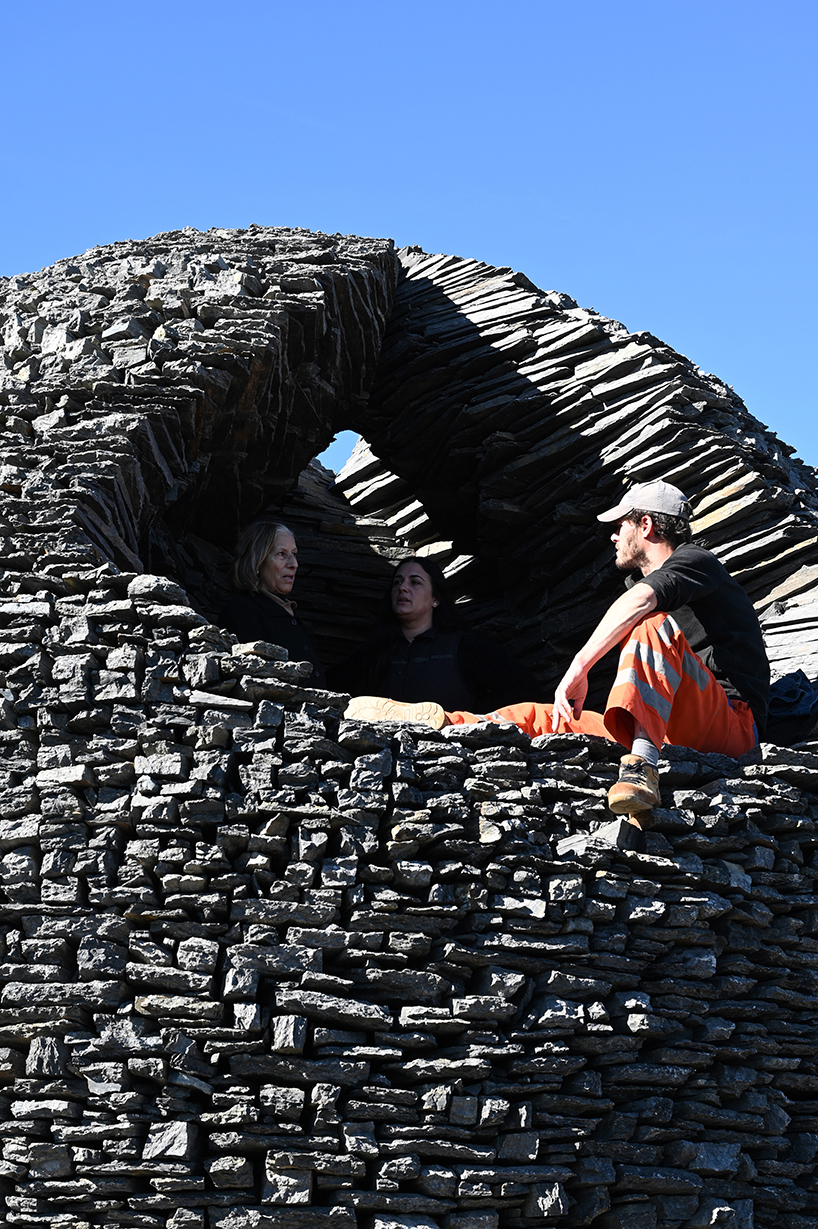 atelier yokyok sculpts sphere land installation out of black schist and granite in portugal