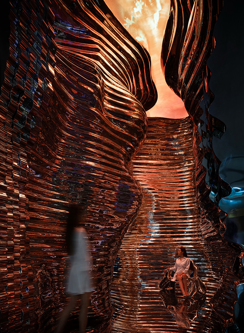 foshan topway design creates reflective canyon-like steel interior for 'zcmetal' exhibition hall in china