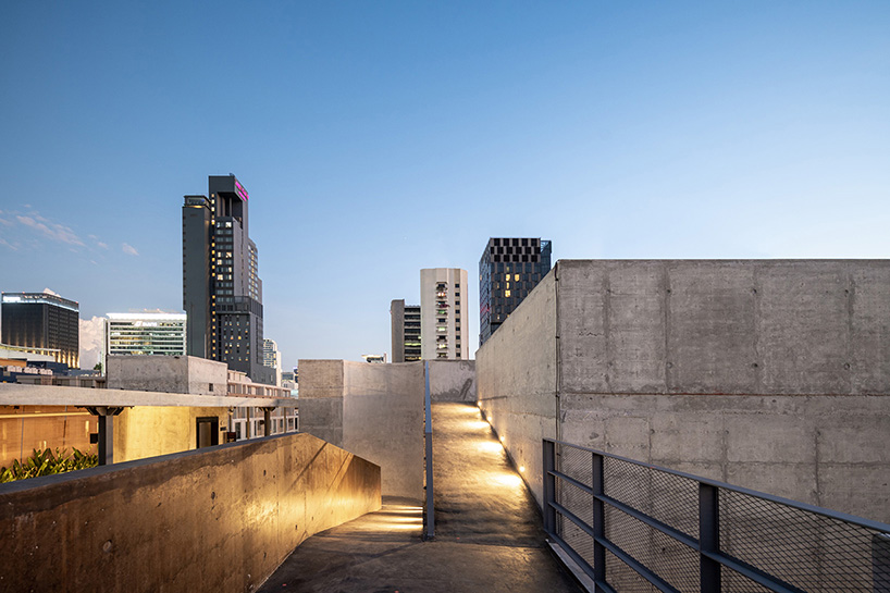porous expanded-metal mesh skin adorns art center's concrete facade in bangkok