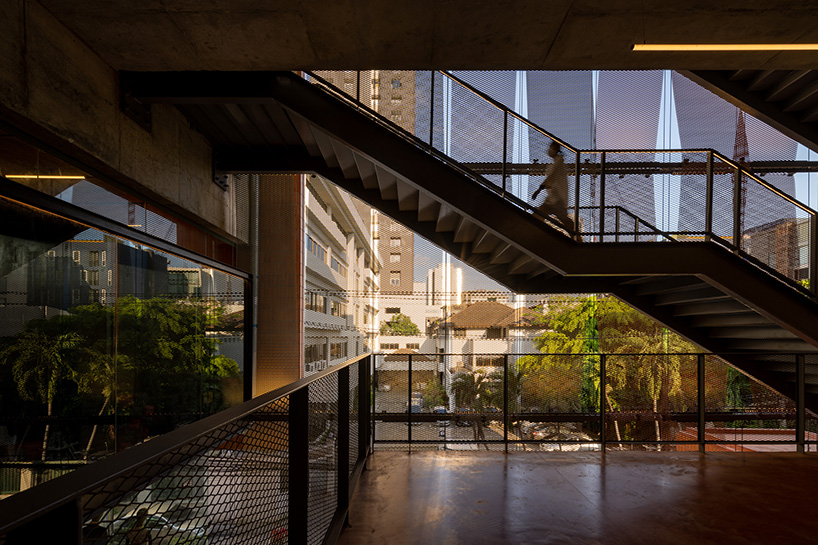 porous expanded-metal mesh skin adorns art center's concrete facade in bangkok