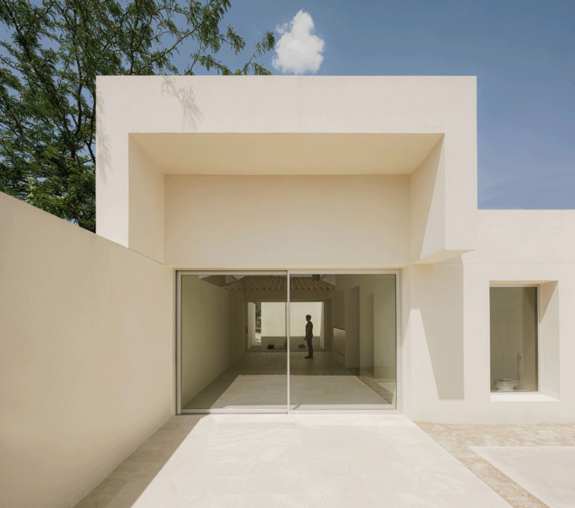 two white volumes outline minimal school expansion in rural spain
