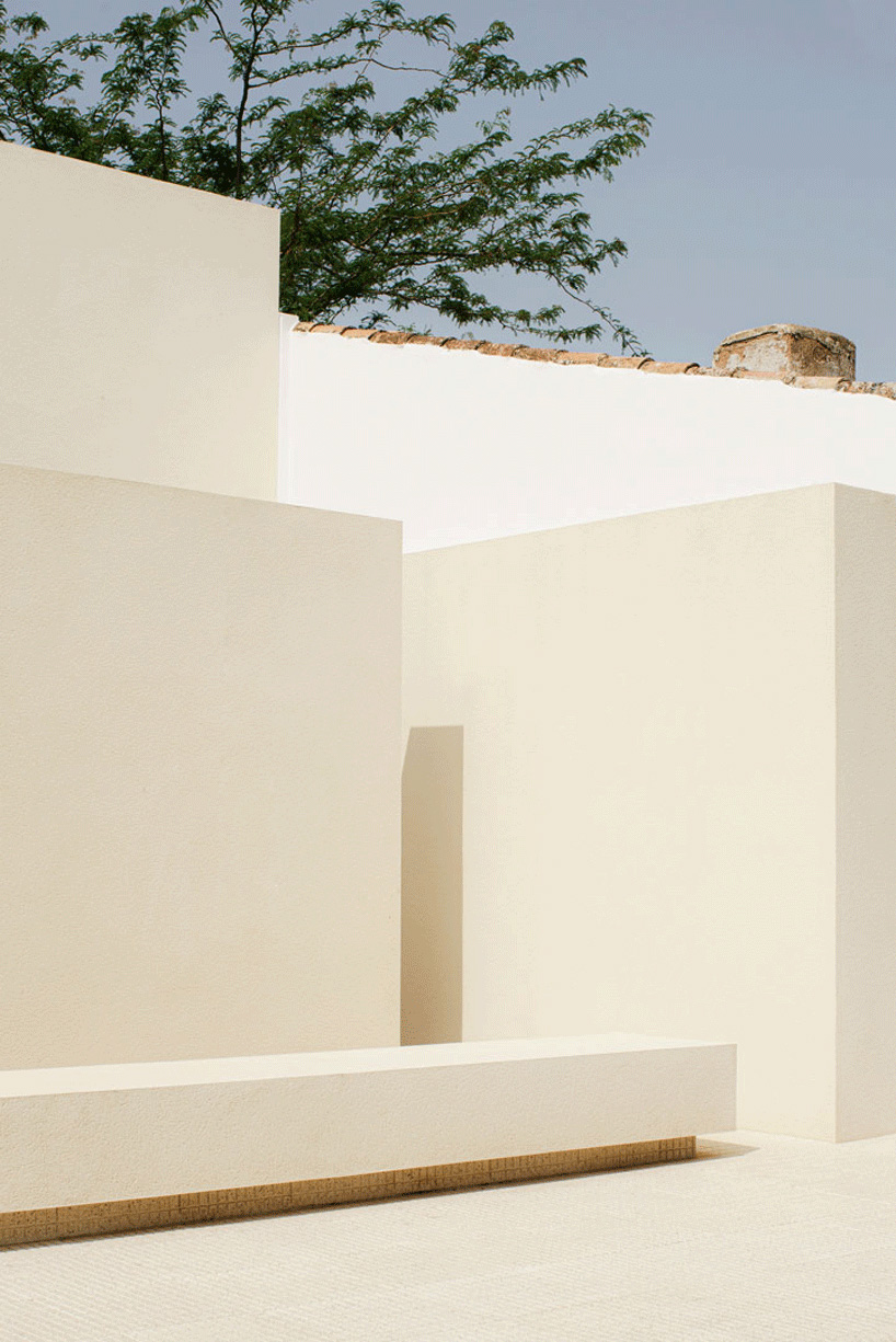 two white volumes outline minimal school expansion in rural spain