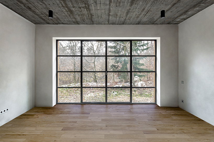 timber-clad cottage jaro by edit! interacts with forest sloping site in the czech republic