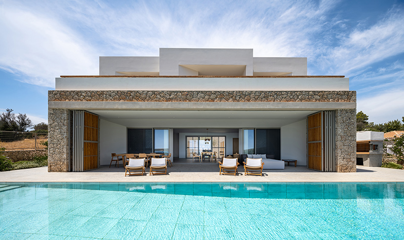 pieris.architects embeds layered stone-and-plaster residence into greek hillside