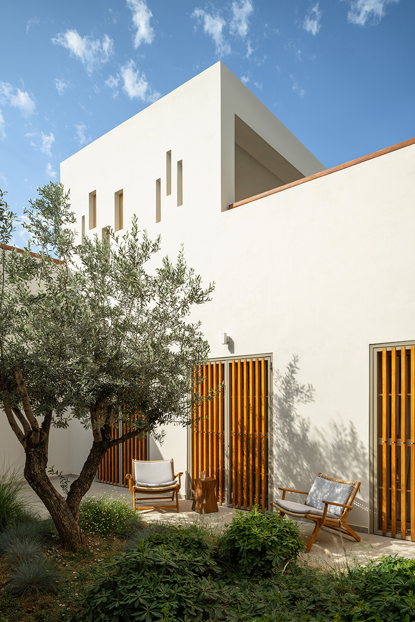 pieris.architects embeds layered stone-and-plaster residence into greek hillside