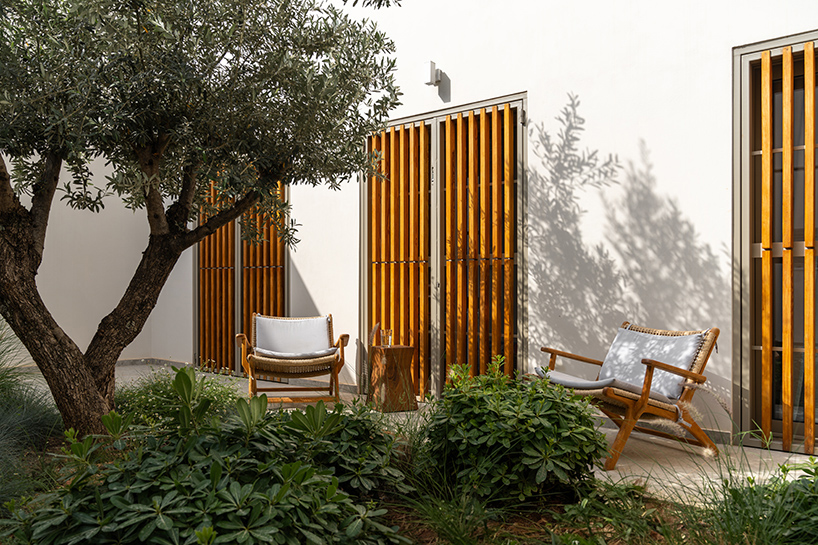 pieris.architects embeds layered stone-and-plaster residence into greek hillside