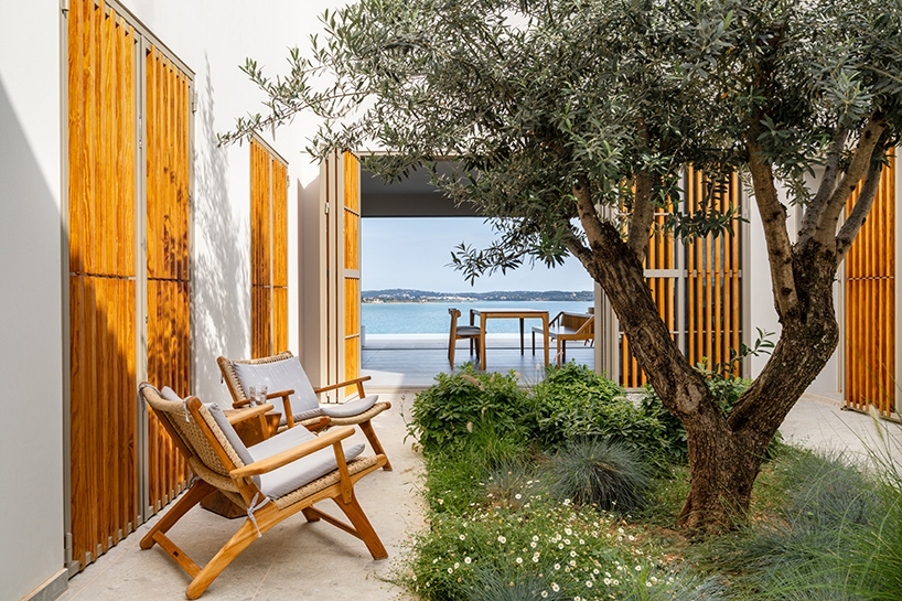 pieris.architects embeds layered stone-and-plaster residence into greek hillside