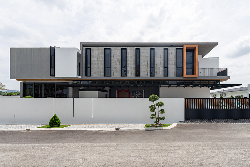 fluted concrete blocks extend 3-juxta house's facade towards streetfront in malaysia