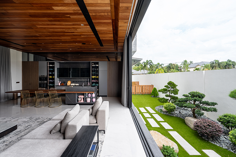 fluted concrete blocks extend 3-juxta house's facade towards streetfront in malaysia