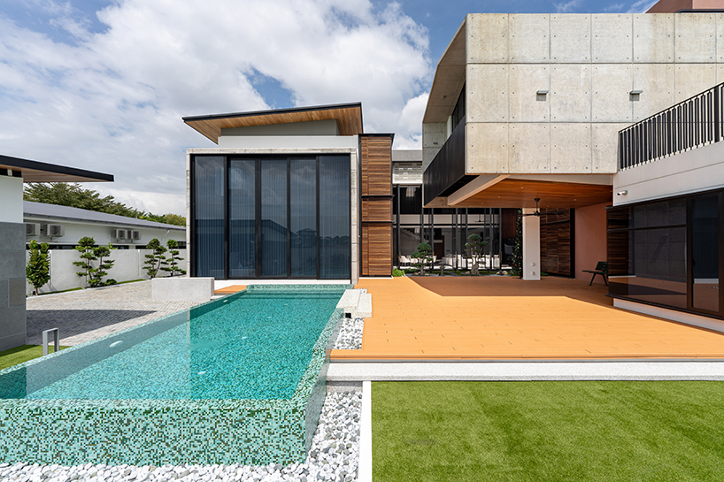 fluted concrete blocks extend 3-juxta house's facade towards streetfront in malaysia