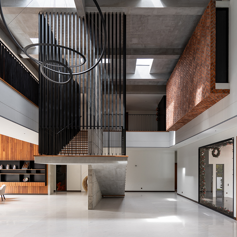 fluted concrete blocks extend 3-juxta house's facade towards streetfront in malaysia