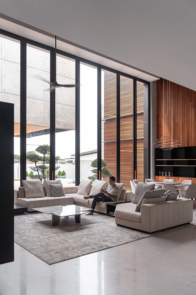 fluted concrete blocks extend 3-juxta house's facade towards streetfront in malaysia