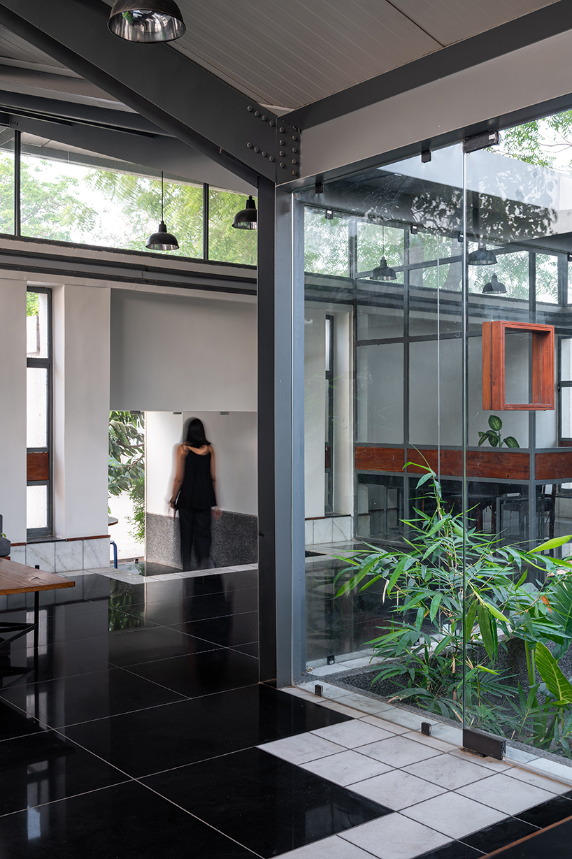 inverted winged hip roof cantilevers over reconstructed office space by compartment S4