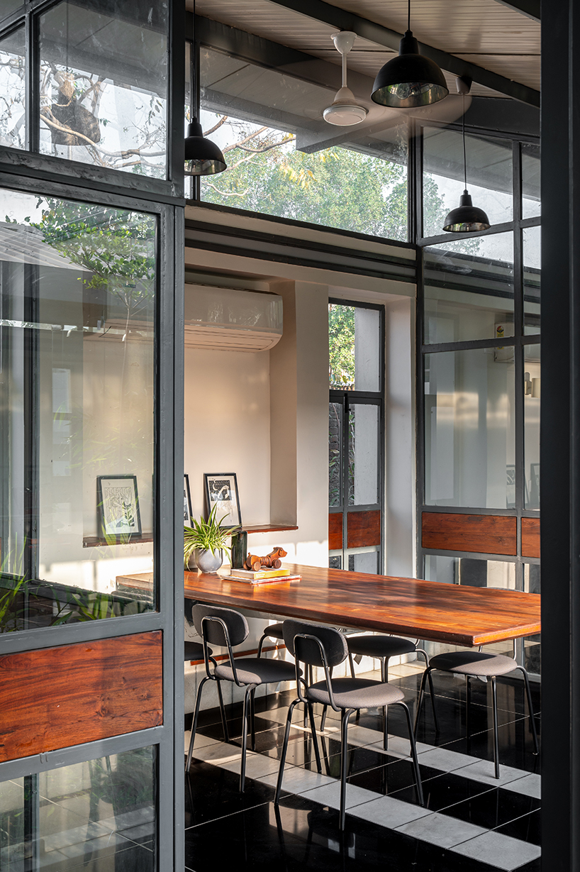 inverted winged hip roof cantilevers over reconstructed office space by compartment S4