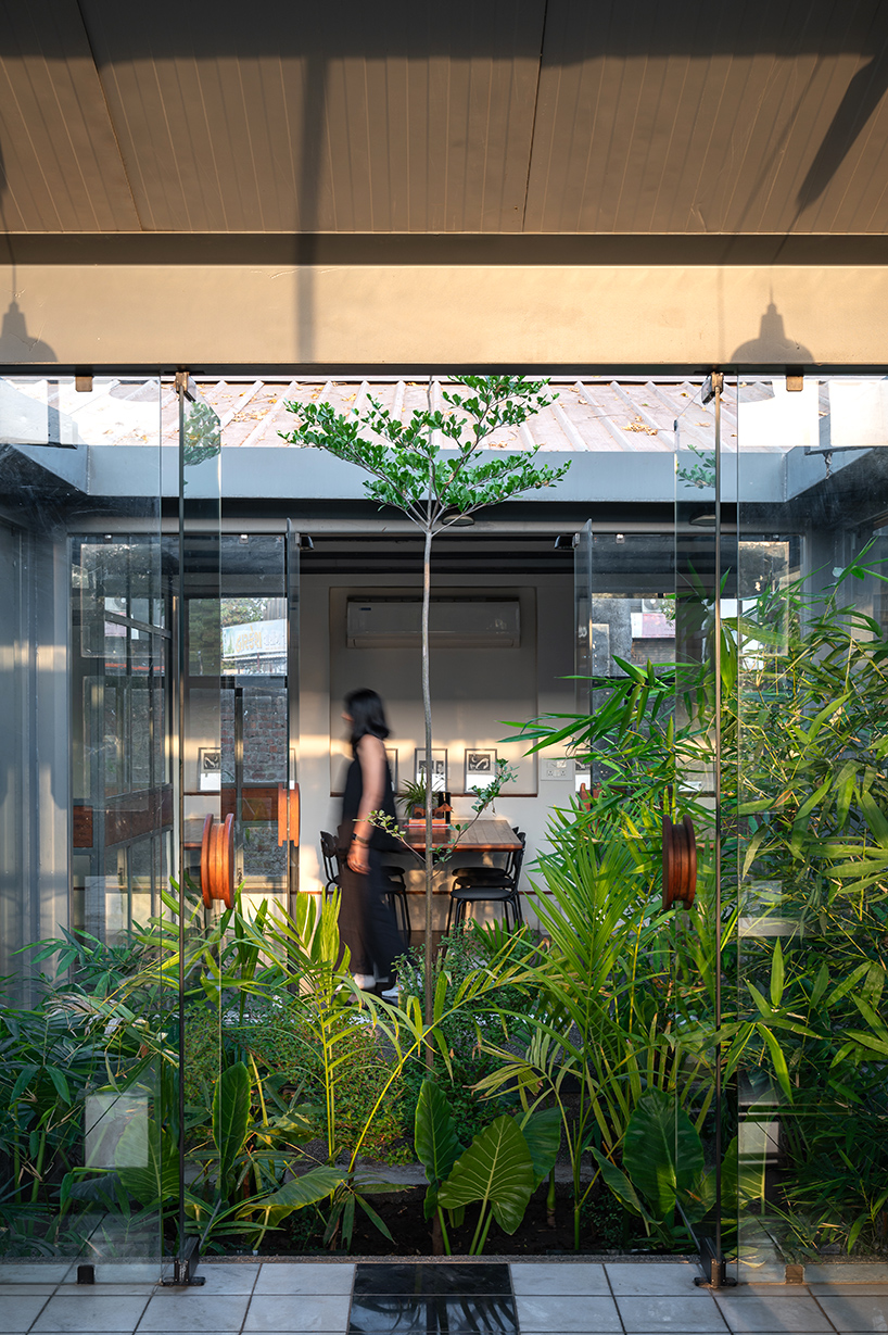 inverted winged hip roof cantilevers over reconstructed office space by compartment S4