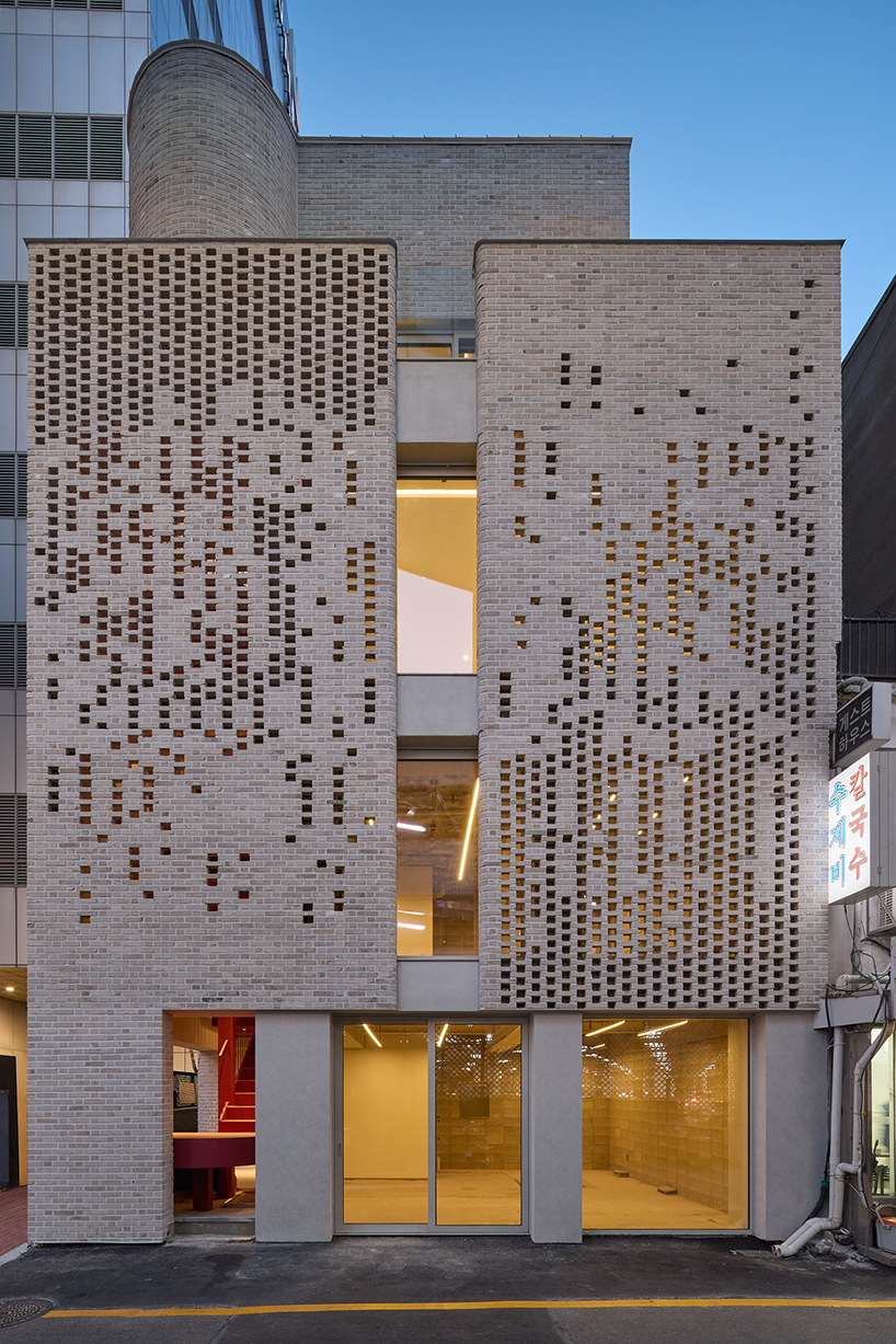 perforated brickwork forms pixelated pattern upon restored seoul building by NOMAL