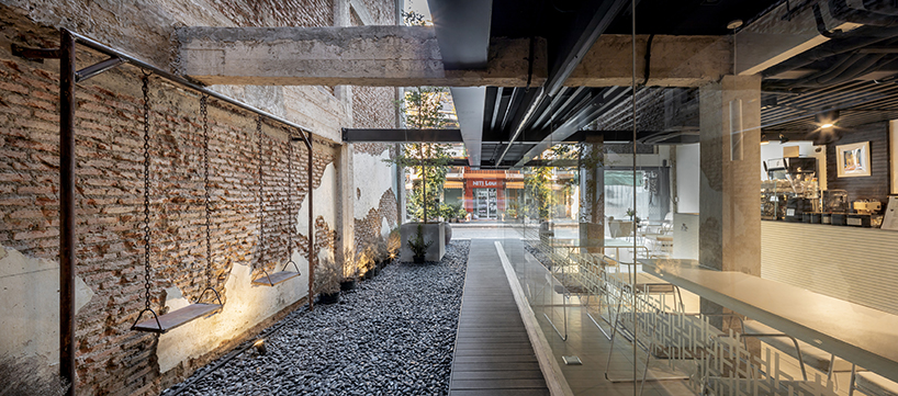 IDIN architects completes pa prank hostel in bangkok with façade of black shutters