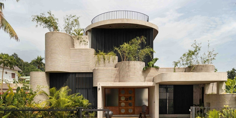 circular green terraces carve through exposed concrete facade in india