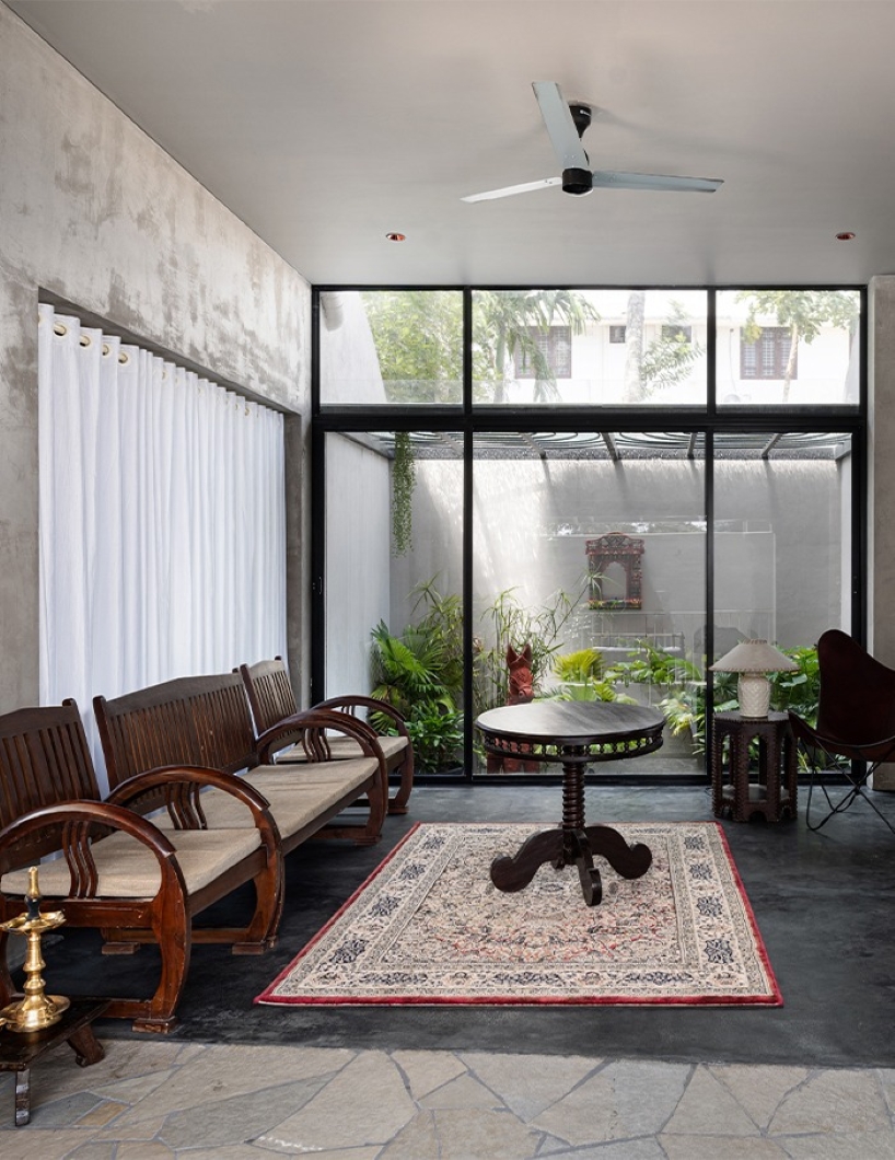 circular green terraces carve through exposed concrete facade in india